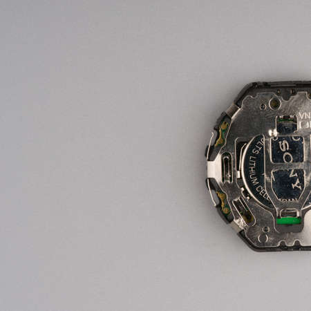 MOSCOW, RUSSIA-February 23, 2022: Half disassembled electronic wristwatch close-up. The internal device and battery are visible. Space for textのeditorial素材