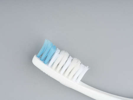 MOSCOW, RUSSIA-February 23, 2022: Branded toothbrush on a light gray background. Closeup. Space for textのeditorial素材