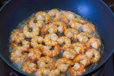 Fried shrimp in oil in a pan closeupの写真素材