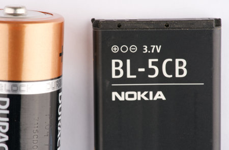 Moscow, Russia-September 15, 2022: A large battery and a battery from a mobile phone. Closeup. View from aboveのeditorial素材