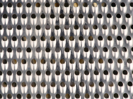 Metallic texture with lots of small holes in silver color. Closeupの写真素材