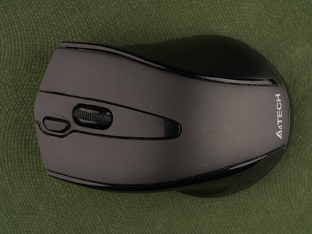 Moscow, Russia-September 16, 2022: A wireless computer mouse entirely on a green background. Closeup. View from aboveのeditorial素材