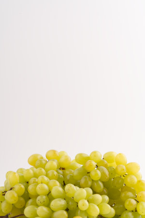 Delicious green grapes on a white background. Vertical snapshotの写真素材