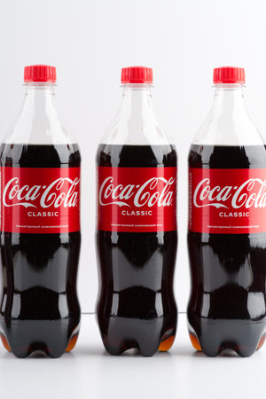 Moscow, Russia-September 16, 2022: Three bottles of Coca Cola on a white background. Vertical snapshotのeditorial素材