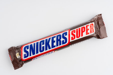 Moscow, Russia-September 16, 2022: A Snickers bar with milk chocolate on a white background. Closeupのeditorial素材