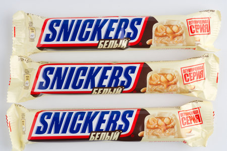 Moscow, Russia-September 16, 2022: Three Snickers bars with white chocolate on a white background. Closeupのeditorial素材