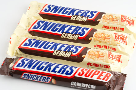 Moscow, Russia-September 16, 2022: Lots of Snickers bars on a white background. Closeupのeditorial素材
