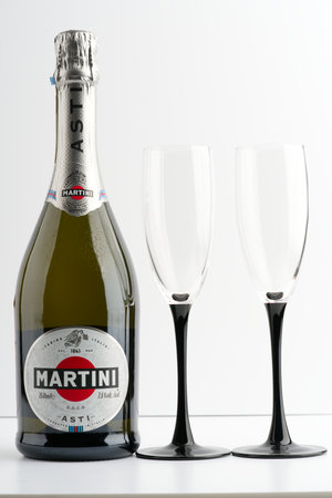 Moscow, Russia-September 16, 2022: A bottle of Martini and two glasses on a white background. Vertical snapshotのeditorial素材