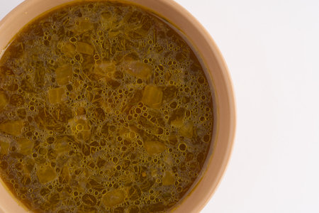 Soup in a plate on a white background. Closeup. Space for textの写真素材