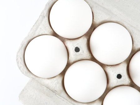 Chicken eggs in a package on a white background. View from above. Closeupの写真素材