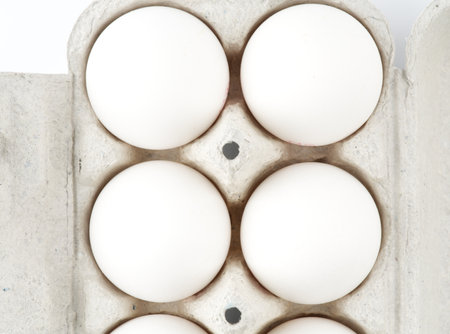 Chicken eggs in a package on a white background. view from above. closeup.の写真素材