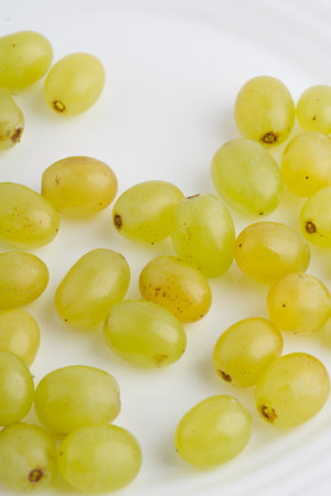 Juicy grapes on a white plate. closeup. vertical shot.の写真素材