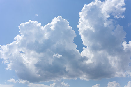 White clouds on a blue sky in summer. Wide angle shotの写真素材