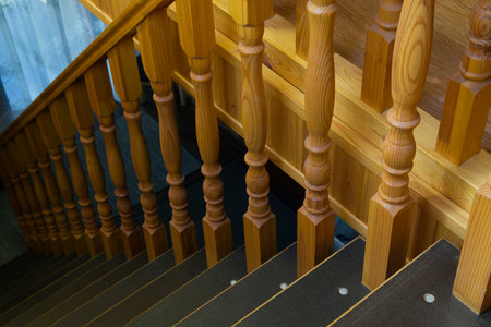 Wooden staircase inside a large house. Carved railings are visibleの写真素材
