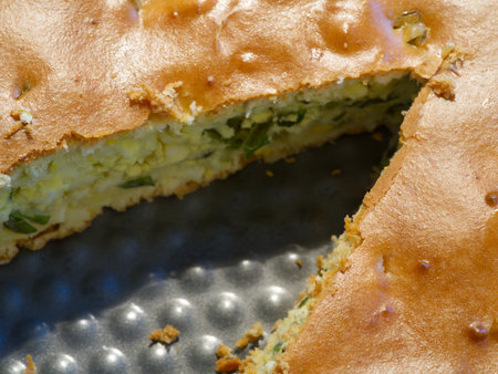 Pie in a baking dish with a piece already cut offの写真素材