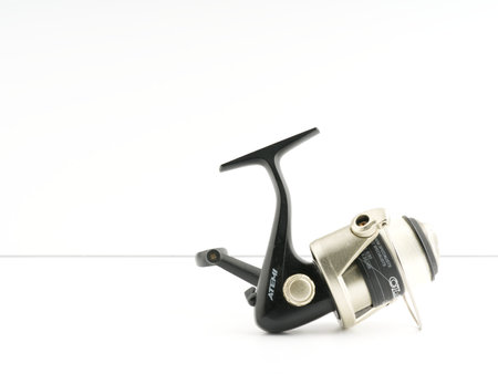 Fishing reel on a white background. Closeup. Place for textのeditorial素材