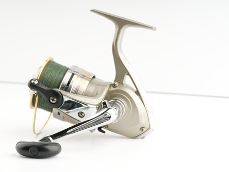 Fishing reel on a white background. Closeupのeditorial素材