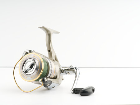 Fishing reel on a white background. Closeup. Place for textのeditorial素材