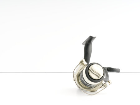 Moscow, Russia-October 16, 2022: Fishing reel on a white background. Closeup. Place for textのeditorial素材