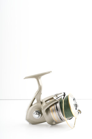 Moscow, Russia-October 16, 2022: Fishing reel on a white background. Closeup. Vertical shotのeditorial素材