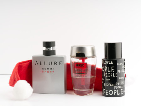 Moscow, Russia-October 16, 2022: A lot of mens branded perfumes and a Santa Claus hat on a white backgroundのeditorial素材