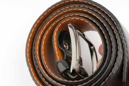 Leather black belt on a white background closeup. Space for textの写真素材