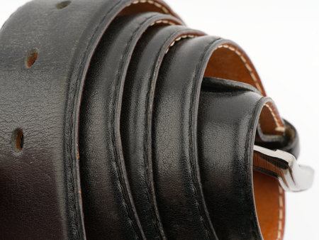 Leather black belt on a white background closeupの写真素材