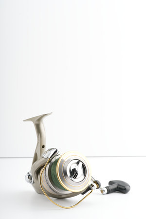Moscow, Russia-October 16, 2022: Fishing reel on a white background. Vertical shotのeditorial素材