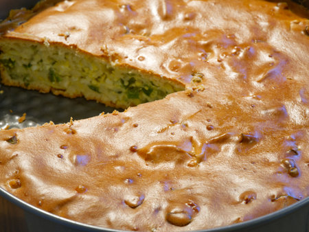 Pie in a baking dish with a piece already cut offの写真素材