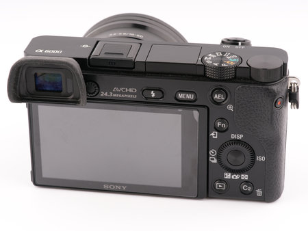 Moscow, Russia-October 16, 2022: The back of the old Sony A6000 mirrorless camera is black on a white background. The screen is visibleのeditorial素材