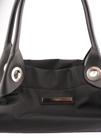 Moscow, Russia-October 16, 2022: Womens branded Calvin Klein bag in black on a white background. Vertical shotのeditorial素材