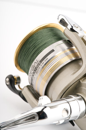Moscow, Russia-October 16, 2022: Branded fishing reel on a white background. Vertical shotのeditorial素材