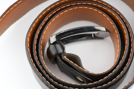 Leather black belt on a white background closeupの写真素材