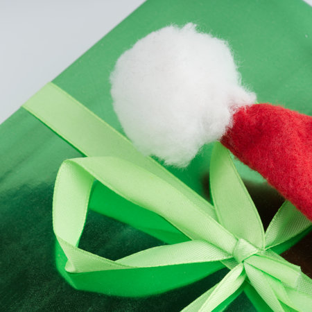 A green New Year gift and a Santa Claus hat closeupの写真素材