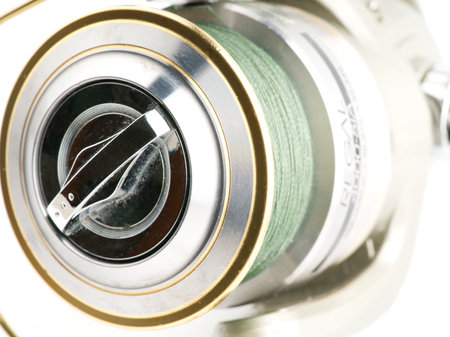 Moscow, Russia-October 16, 2022: Branded fishing reel on a white background. The spool is visible. Closeupのeditorial素材