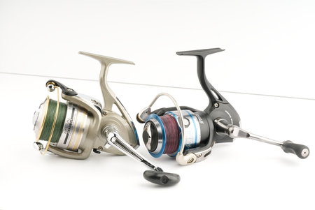Moscow, Russia-October 16, 2022: Two different branded fishing reels on a white backgroundのeditorial素材