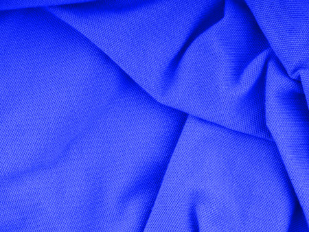 The texture of the crumpled blue fabric forming a patternの写真素材