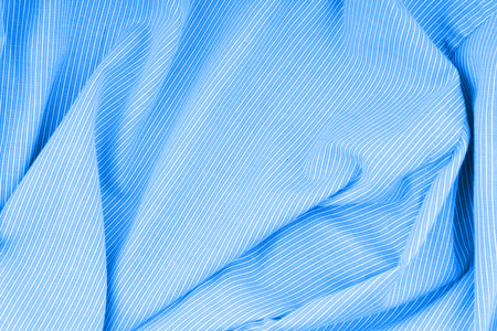 The texture of the crumpled fabric is light blue. Forming a pattern. Top viewの写真素材