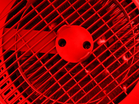 The concept of life-threatening heat. The fan is in bright red colorsの写真素材