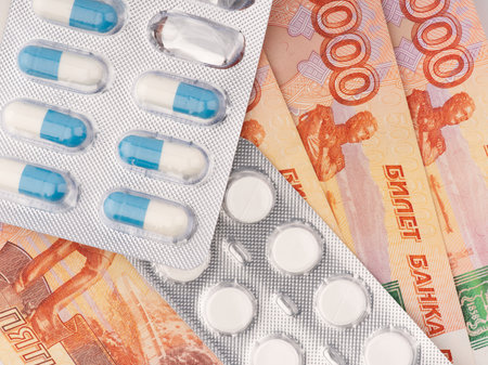 Money and pills. There is not enough money for treatment. Conceptの写真素材