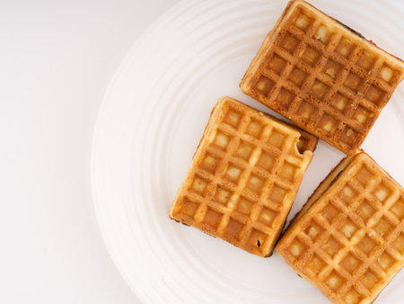 Baked waffles on a white plate. Flatlay. Place for textの写真素材