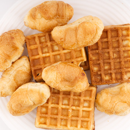 Baked waffles and small buns on a white plate. Flatlayの写真素材