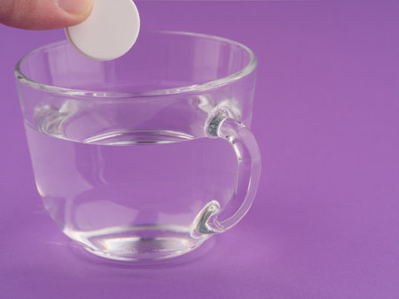 The concept of taking medications. A cup and a pill is put in itの写真素材
