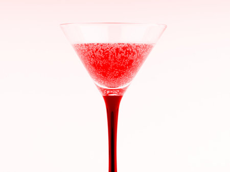 Cocktail in an elegant glass on a high leg. In red colors. In the style of a nightclubの写真素材