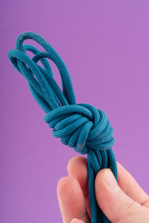 Laces from sports sneakers in your hand. Closeup. Vertical shotの写真素材