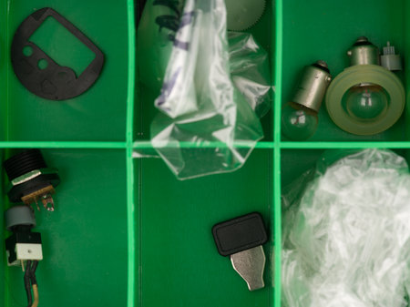 The parts are in the box of a person engaged in repairing electronics. View from above. Closeupの写真素材