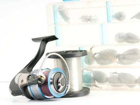 Moscow, Russia-October 16, 2022: Branded English fishing reel with a fishing line mat and weights in a box in the backgroundのeditorial素材