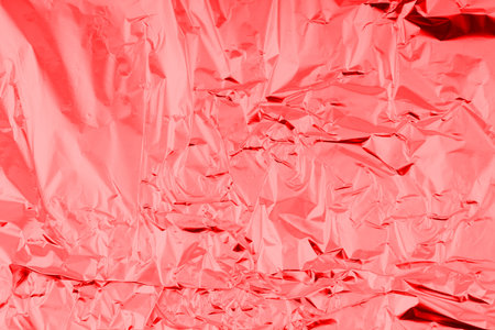Abstract texture of slightly crumpled red foil. Closeupの写真素材