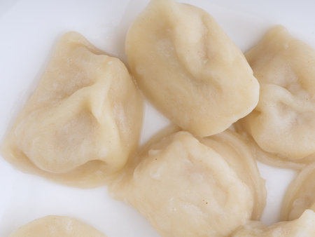 Cooked dumplings on a white plate. Flatlay. Closeupの写真素材