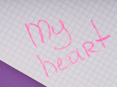 The concept of warm feelings. The inscription on the notebook sheet with a pink marker my heartの写真素材
